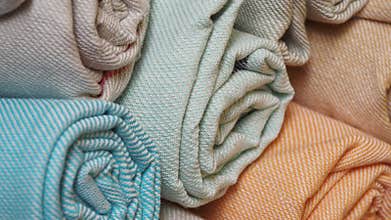 Colorful rolled fabrics displayed at a textile market