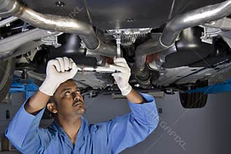 Auto mechanic under car