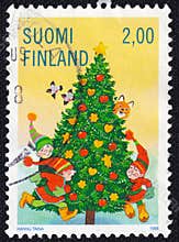Elves playing around a decorated Christmas tree.