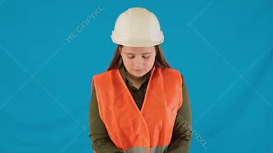 Responsible female builder adjusts protective gloves