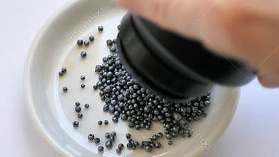 Dumping iodine crystals (granules) at the white dish