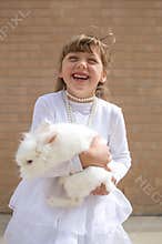Happy girl with pet rabbit
