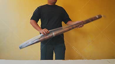 Person Holding Transparent Umbrella Against Yellow Wall