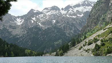 View of the Snow-capped Peaks from the Mountain Lakeside in Summer. Alpine Landscape.