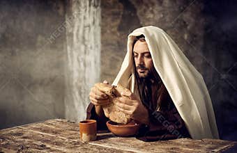 Jesus breaks the bread