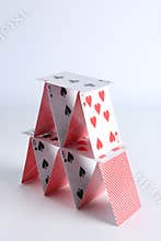 House of playing cards on white background