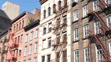 New York City building architecture, Manhattan. Residential house exterior. Red brick, fire escape.
