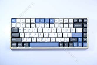 Top-down view of a white 75% mechanical keyboard with blue and dark keycaps, showcasing a minimalist and modern aesthetic.
