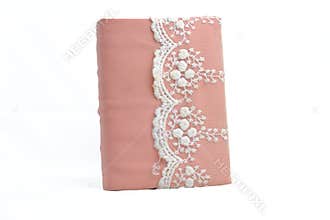 Light pink Quran cover on a white background.