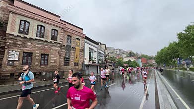 Athletes running Istanbul half marathon in historic street of Fener district