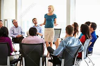Businesswoman Addressing Multi-Cultural Office Staff Meeting