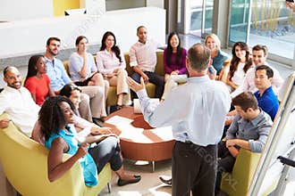 Businessman Making Presentation To Office Colleagues