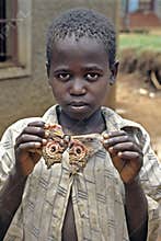 Ugandan boy proudly poses with colorful moth