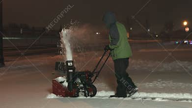 Teenager snow blowing back angle 1080p 4K UHD
