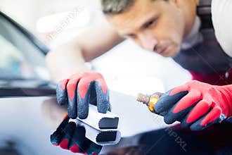 Man worker on a car wash
