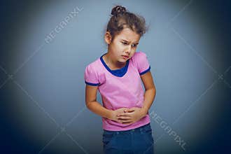 Girl child abdominal pain on gray background cross