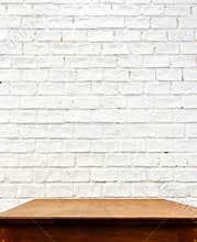 White brick wall and wooden table