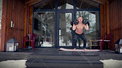 Dumbbell workout on the terrace at home.