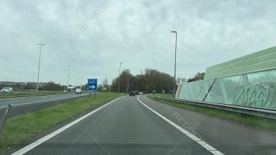 Blue road sign over multi-lane highway in Amsterdam suburb