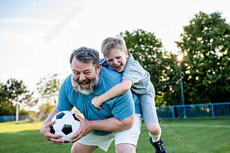 Dad and son sharing passion for football and active lifestyle.