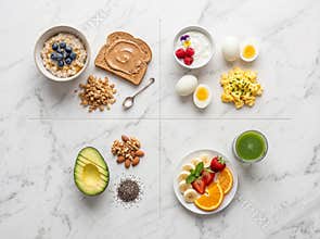 Top view shows a variety of healthy morning meal options organized into four distinct sections on a grey marble surface
