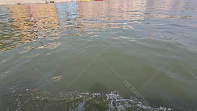 Close-up of river water surface with ripples created by a moving boat