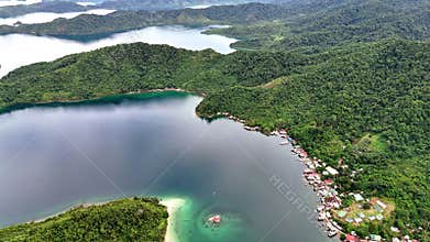 Push-in tilt-up shot of a house on a shoal in Palawan, Philippines. The drone rises from t