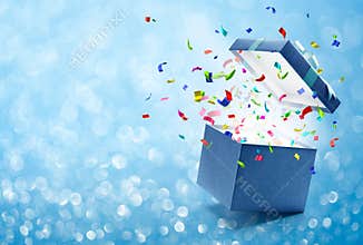 Confetti popping out from blue gift box