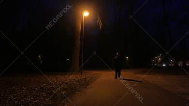 Portrait of Dangerous aggressive man with a knife in the dark. Outdoors.