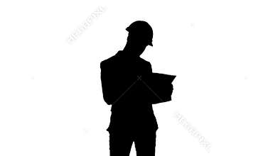 Silhouette Architect in helmet checking construction plan