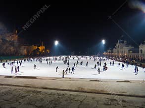 Crowd on outdoor ice rink by night in Budapest