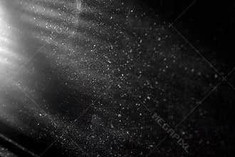 Abstract texture with dust and spots of light. Black tone glitter background. Glitter background with shine or ray