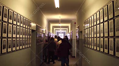 OSWIENCIM, POLAND - JANUARY, 14, 2017 Steadicam shot of guided tour and portraits of Auschwitz Birkenau victims. German