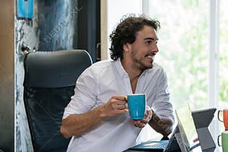 Employee in creative industries having coffee and talk