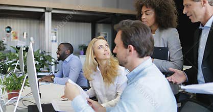 Business people group disscuss strategy pointing on computer monitor working together in creative office space