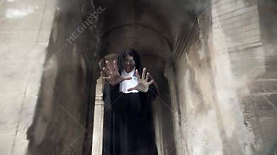 The ghost of a nun walks through the ruins of an old monastery. 4 k. Slow-motion shooting