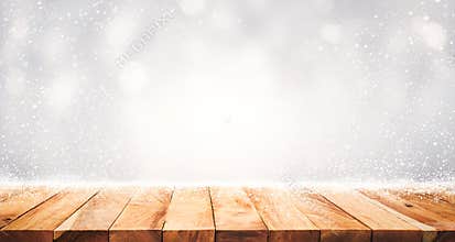 Wood table top with snowfall of winter season background. christmas