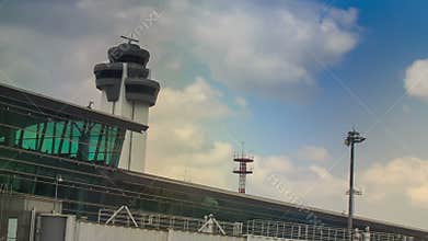 Control tower radar by airport terminal building against sky
