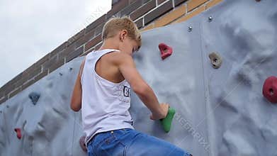 The teenager down the wall for climbing. Sports Outdoors