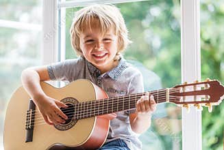 Boy playing acoustic guitar