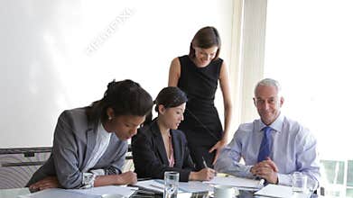 Group Of Businesspeople Having Meeting At Desk In Office