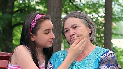 Sad grandmother with her little granddaughter