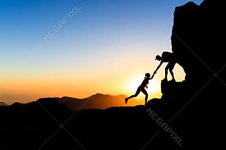 Teamwork couple climbing helping hand