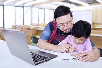 Elementary school teacher helps his student