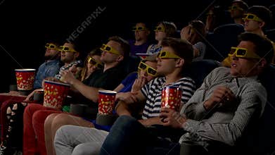 Young people watch movies in cinema: horror in 3D