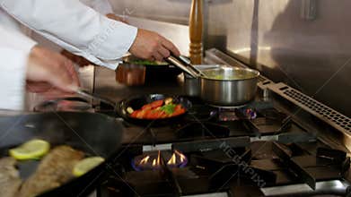 Four chefs cooking and working