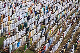 Muslim prayer. A group of Muslim are praying. They weared different color dress.