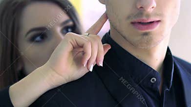 Pretty brunette touching male face by her finger. Slow motion