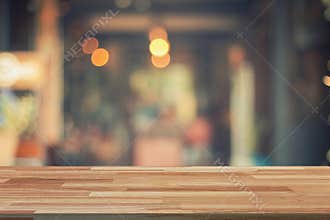 Empty wood table and Blurred background display at coffee shop