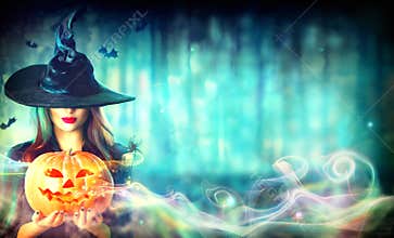 witch with a Halloween pumpkin Jack-o-lantern